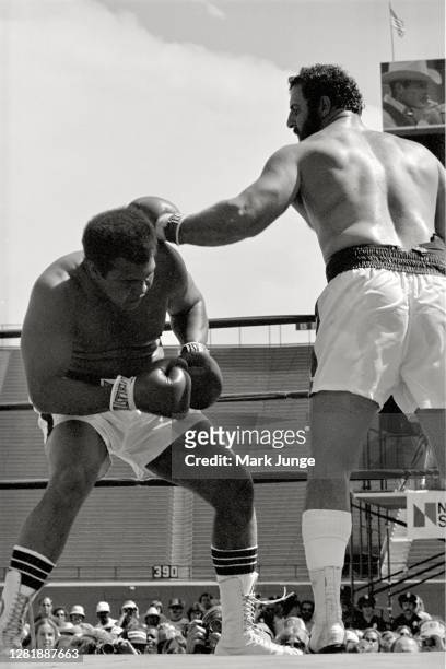 Muhammad Ali , ducks under a left jab from Lyle Alzado during an eight-round exhibition match at Mile High Stadium on July 14, 1979 in Denver,...