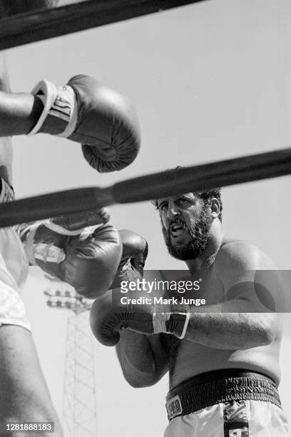 Lyle Alzado , advances toward Muhammad Ali who is against the ropes during an eight-round exhibition match at Mile High Stadium on July 14, 1979 in...