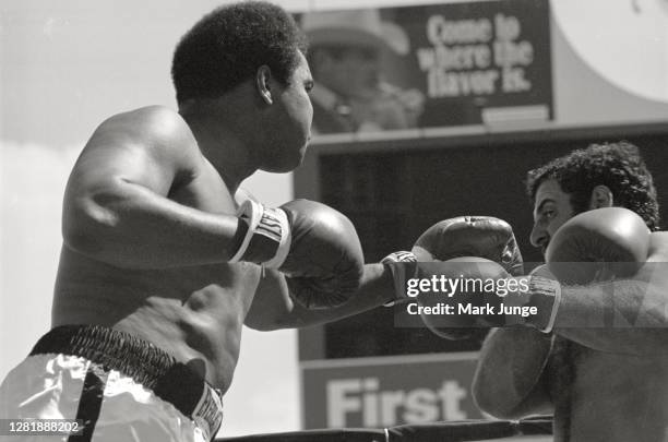 Muhammad Ali , throws a left jab against Lyle Alzado during an eight-round exhibition match at Mile High Stadium on July 14, 1979 in Denver,...