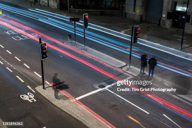 high angle view of traffic on a busy city street at night - traffic light city stock-fotos und bilder