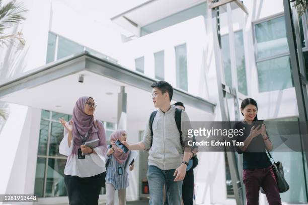 group of asian university student walking out from education building talking - malaysia school stock pictures, royalty-free photos & images