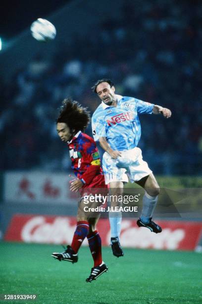 Salvatore Schillaci of Jubilo Iwata and Yasuto Honda of Kashima Antlers compete for the ball during the J.League match between Kashima Antlers and...
