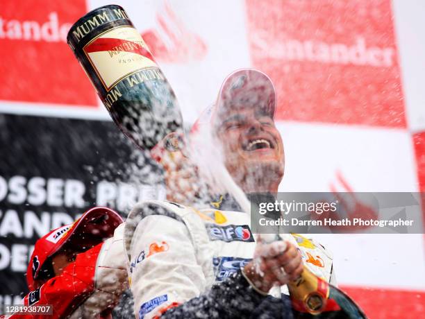 Brazilian Renault Formula One driver Nelson Piquet Junior celebrates by spraying champagne on the winners podium after finishing second at the 2008...
