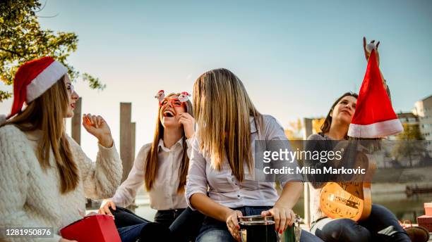 a group of women celebrate the new year outside, by the lake, the new year in the warmer part of the planet - summer christmas stock pictures, royalty-free photos & images