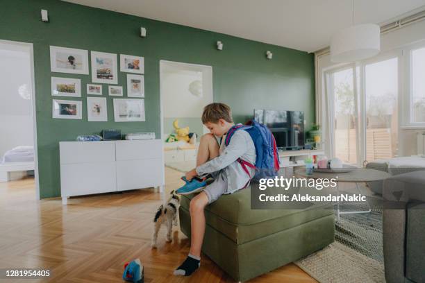 getting ready for school - boy getting dressed stock pictures, royalty-free photos & images