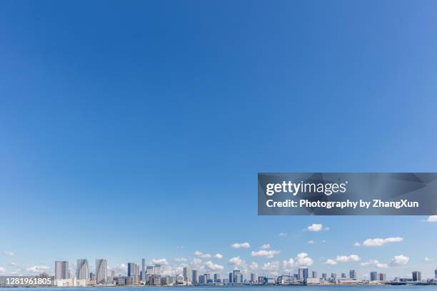 tokyo skyline with residential and office buildings against clear blue sky, japan. - clear sky city stock pictures, royalty-free photos & images