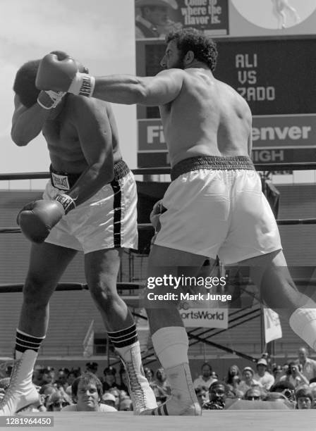 Muhammad Ali , blocks a left hook from Lyle Alzado during an eight-round exhibition match at Mile High Stadium on July 14, 1979 in Denver, Colorado....