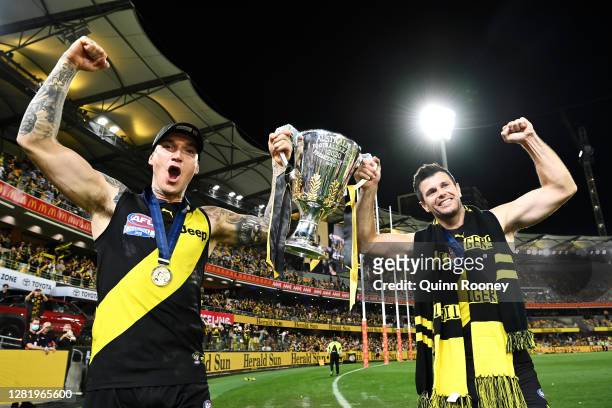 Dustin Martin of the Tigers celebrates with the AFL Premiership Cup and captain Trent Cotchin of the Tigers after winning the 2020 AFL Grand Final...