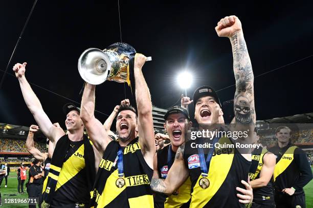 Dustin Martin of the Tigers celebrates with captain Trent Cotchin of the Tigers after winning the 2020 AFL Grand Final match between the Richmond...