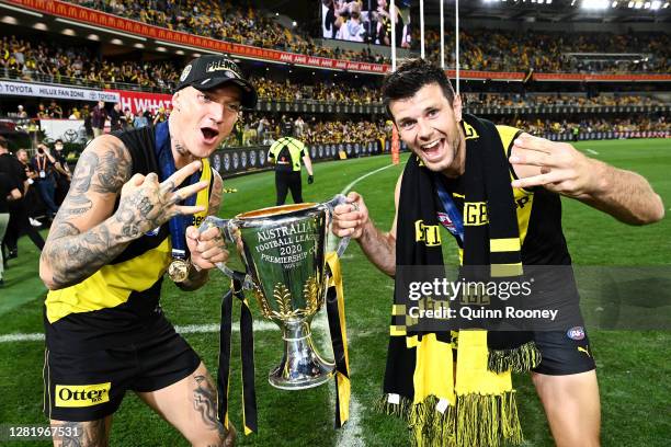 Dustin Martin of the Tigers celebrates with the AFL Premiership Cup and captain Trent Cotchin of the Tigers after winning the 2020 AFL Grand Final...