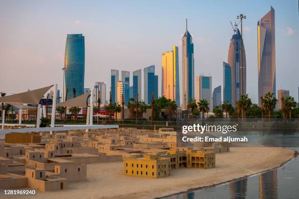 green roofed buildings sit atop the al shaheed park, kuwait - kuwait landscape stock pictures, royalty-free photos & images