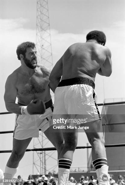 Lyle Alzado ,attempts to throw a right uppercut against Muhammad Ali during an eight-round exhibition match at Mile High Stadium on July 14, 1979 in...