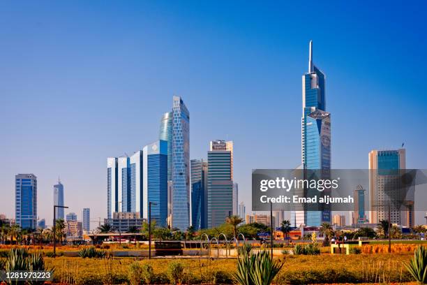 green roofed buildings sit atop the al shaheed park, kuwait - kuwait landscape stock pictures, royalty-free photos & images