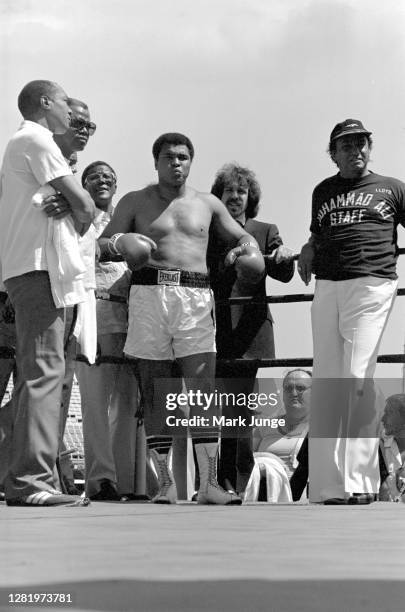 Muhammad Ali stands in his corner flanked by his assistants during an eight-round exhibition match with Lyle Alzado at Mile High Stadium on July 14,...