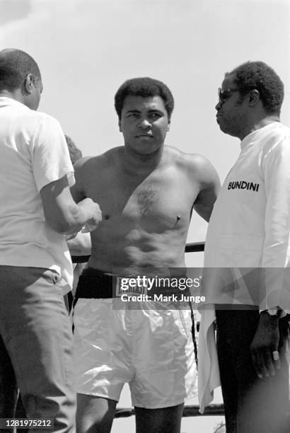 Muhammad Ali stands in his corner flanked by his assistants during an eight-round exhibition match with Lyle Alzado at Mile High Stadium on July 14,...