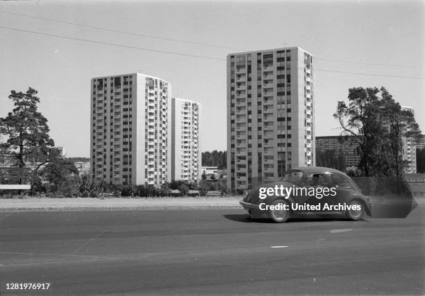 Germany - VW Beetle on the move in a new housing estate, 1960s. VW Beetle on the road, 1960s.