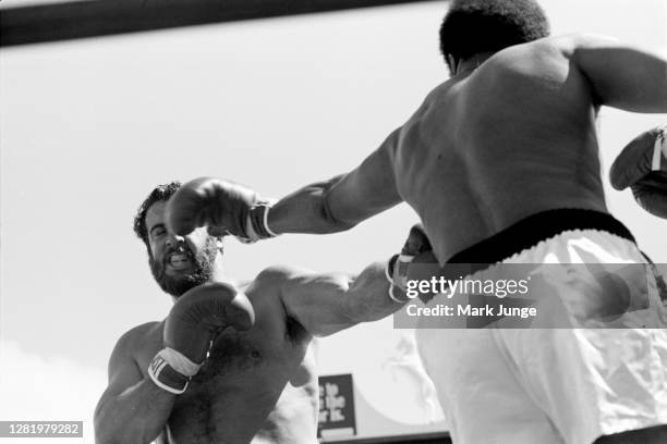 Muhammad Ali , throws a left jab against Lyle Alzado during an eight-round exhibition match at Mile High Stadium on July 14, 1979 in Denver,...