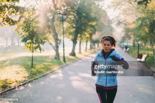 jogging in autumn park - winter stock pictures, royalty-free photos & images