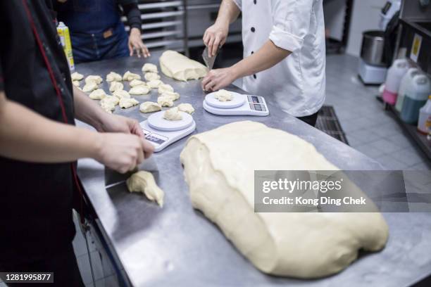 asian chinese bakers preparing dough in commercial kitchen bakery - changing form stock pictures, royalty-free photos & images