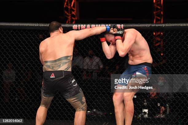 Tai Tuivasa of Australia punches Stefan Struve of The Netherlands in their heavyweight bout during the UFC 254 event on October 24, 2020 on UFC Fight...