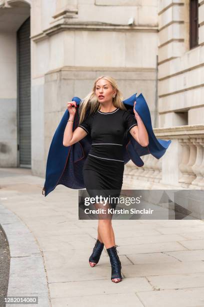 Influencer and model Lexi Fargo wears a Louis Vuitton coat, Orsay dress, Dior runway collection boots and Chanel earrings during LFW September 2020...