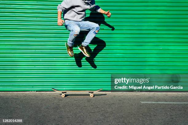 green wall skater - stock photo - metal wall stock pictures, royalty-free photos & images