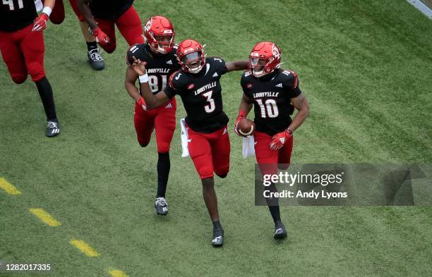 Malik Cunningham of the Louisville Cardinals celebrates after throwing a touchdown pass to Javian Hawkins against the Florida State Seminoles at...