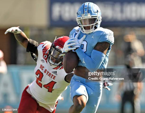 Malik Dunlap of the North Carolina State Wolfpack breaks up a pass intended for Dyami Brown of the North Carolina Tar Heels during their game at...