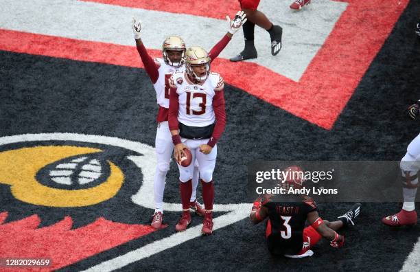 Jordan Travis of the Florida State Seminoles celebrates after running for a touchdown against the Louisville Cardinals at Cardinal Stadium on October...
