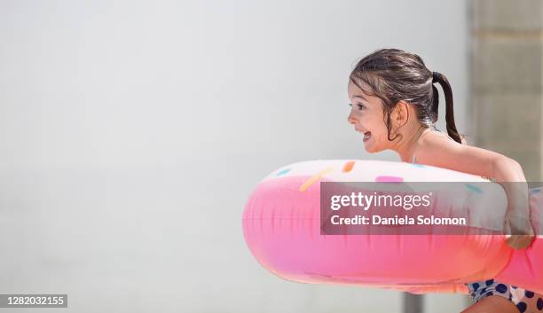 cute girl enjoying water in the swimming pool - kids pool games stock-fotos und bilder