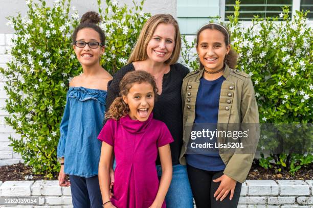 single mother with three mixed race children in happy family portrait - foster parent stock pictures, royalty-free photos & images