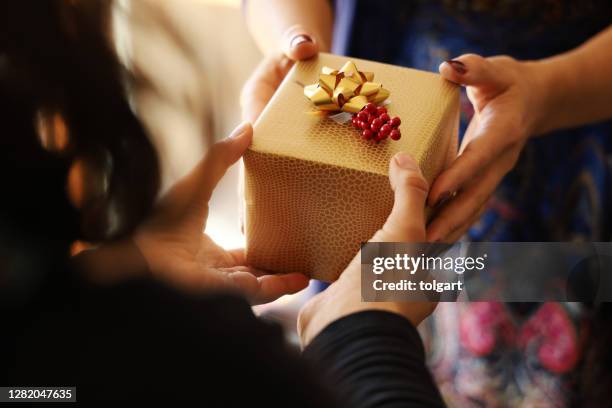 hands giving gift close-up - exchanging gifts stock pictures, royalty-free photos & images