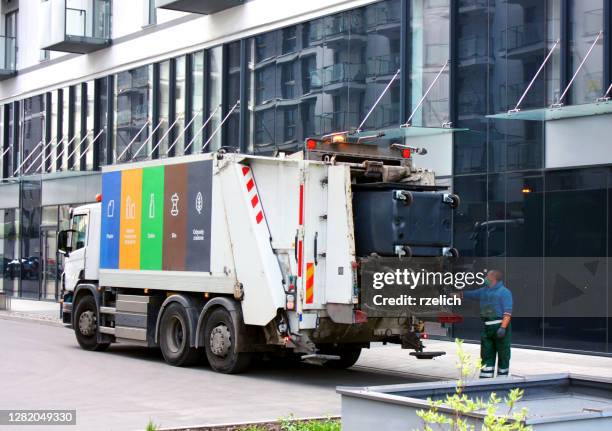 refuse collection worker with covid mask emptying container - dustbin lorry stock pictures, royalty-free photos & images