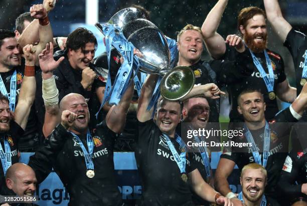 Joe Simmonds and Jack Yeandle, the co captains of Exeter Chiefs, raise the Premiership trophy as they celebrate with team mates after their victory...