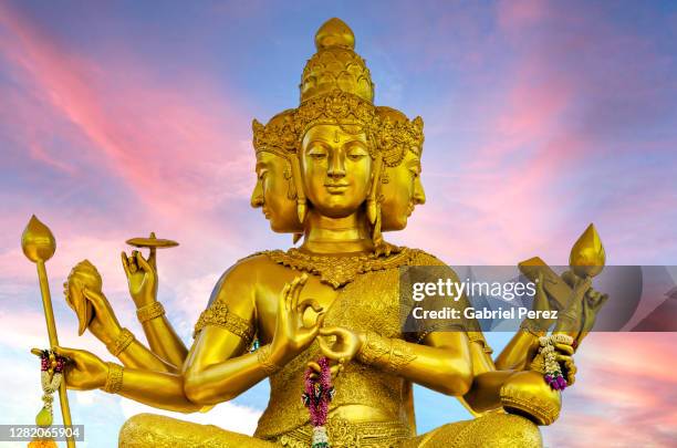 a statue of brahma - gold statue stock pictures, royalty-free photos & images