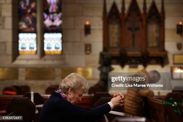 Parishioners pray during the 'Twenty-First Sunday after Pentecost' service with Father James Collins at St Paul's Anglican Church in Burwood on...