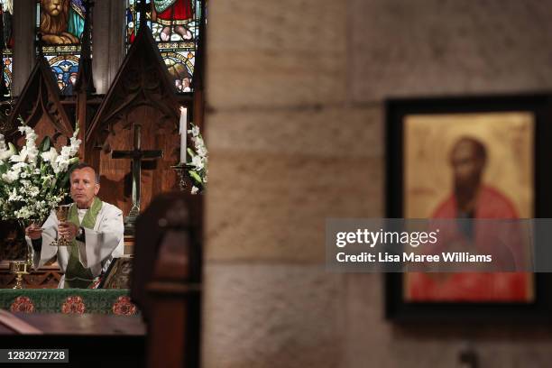 Father James Collins conducts the 'Twenty-First Sunday after Pentecost' service at St Paul's Anglican Church in Burwood on October 25, 2020 in...