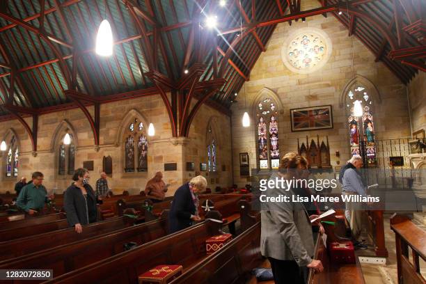 Parishioners stand to sing during the 'Twenty-First Sunday after Pentecost' service at St Paul's Anglican Church in Burwood on October 25, 2020 in...