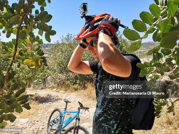 portrait of an italian cyclist in the middle of the unspoiled nature in italy - go pro camera stock pictures, royalty-free photos & images