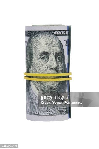 hundred dollar bills rolled up with rubber band. - 100 dollar bill new stock-fotos und bilder