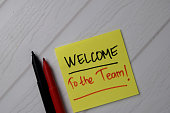 Welcome To The Team! text on sticky notes with office desk.