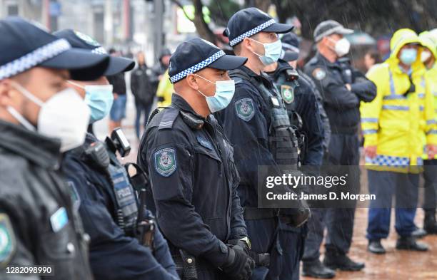 Police officers in facemasks line up to prevent an attempt by anti-lockdown protestors to gather outside ANZ Stadium on October 25, 2020 in Sydney,...