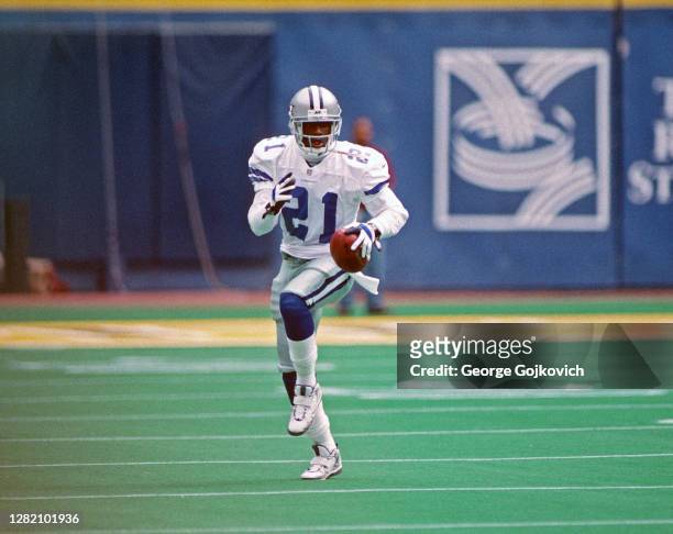 Punt returner Deion Sanders of the Dallas Cowboys runs with the football against the Pittsburgh Steelers during a game at Three Rivers Stadium on...
