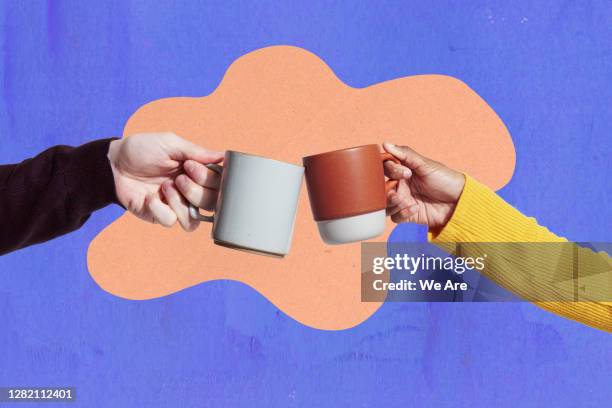 two coffee mugs touching - anstoßen stock-fotos und bilder
