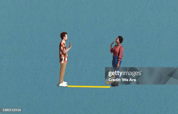 two people in social distancing - ver stockfoto's en -beelden