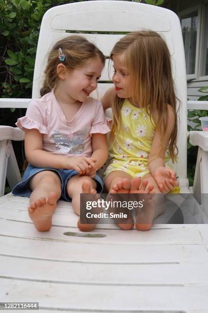 two young girls looking at each other affectionately - 2 peas in a pod stock pictures, royalty-free photos & images