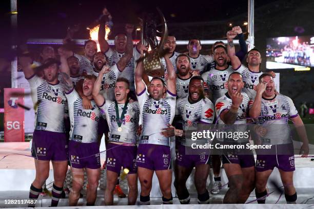 Cameron Smith of the Storm holds aloft the Premiership trophy and celebrates with team mates after winning the 2020 NRL Grand Final match between the...