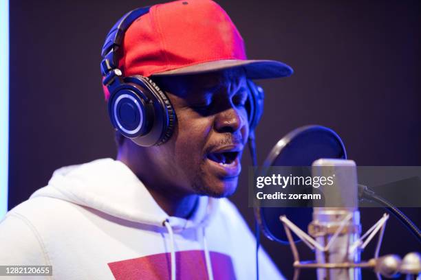 african-american man singing in studio emotionally with eyes closed - pop reggae stock pictures, royalty-free photos & images