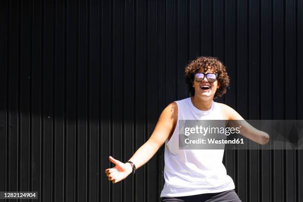 happy amputee boy dancing against shutter - amputado imagens e fotografias de stock