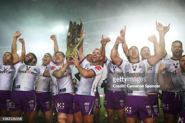 Cameron Munster of the Storm and Cameron Smith of the Storm celebrate with team mates after winning the 2020 NRL Grand Final match between the...